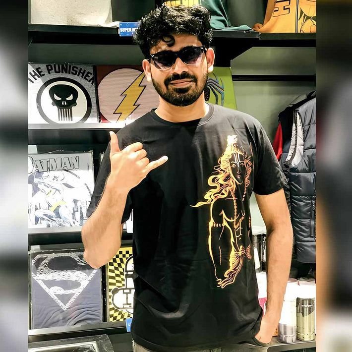 Man wearing a WYO black t-shirt with a graphic design, making a hand gesture in a store setting.