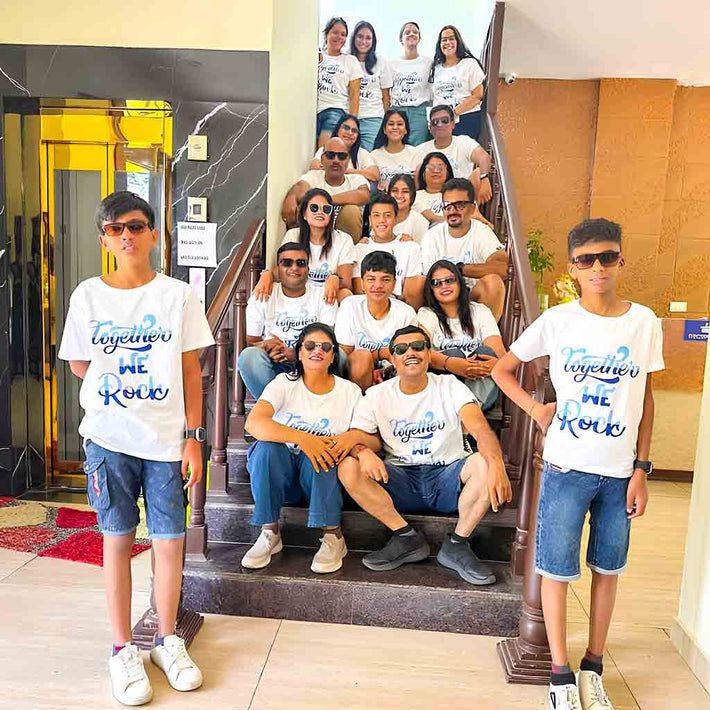 Group of people wearing WYO matching white t-shirts with text in an indoor setting.