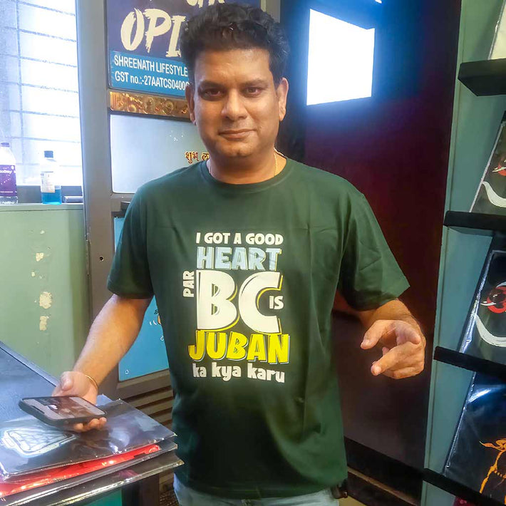 Man wearing a WYO custom t-shirt with text, standing indoors with a blurred background