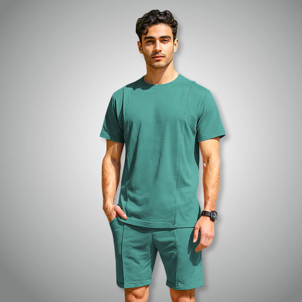 Man wearing a WYO green t-shirt and shorts set on a gray background