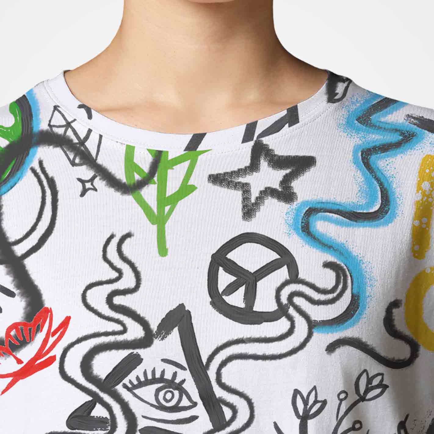 Close-up of a WYO white T-shirt with colorful abstract designs on a plain background