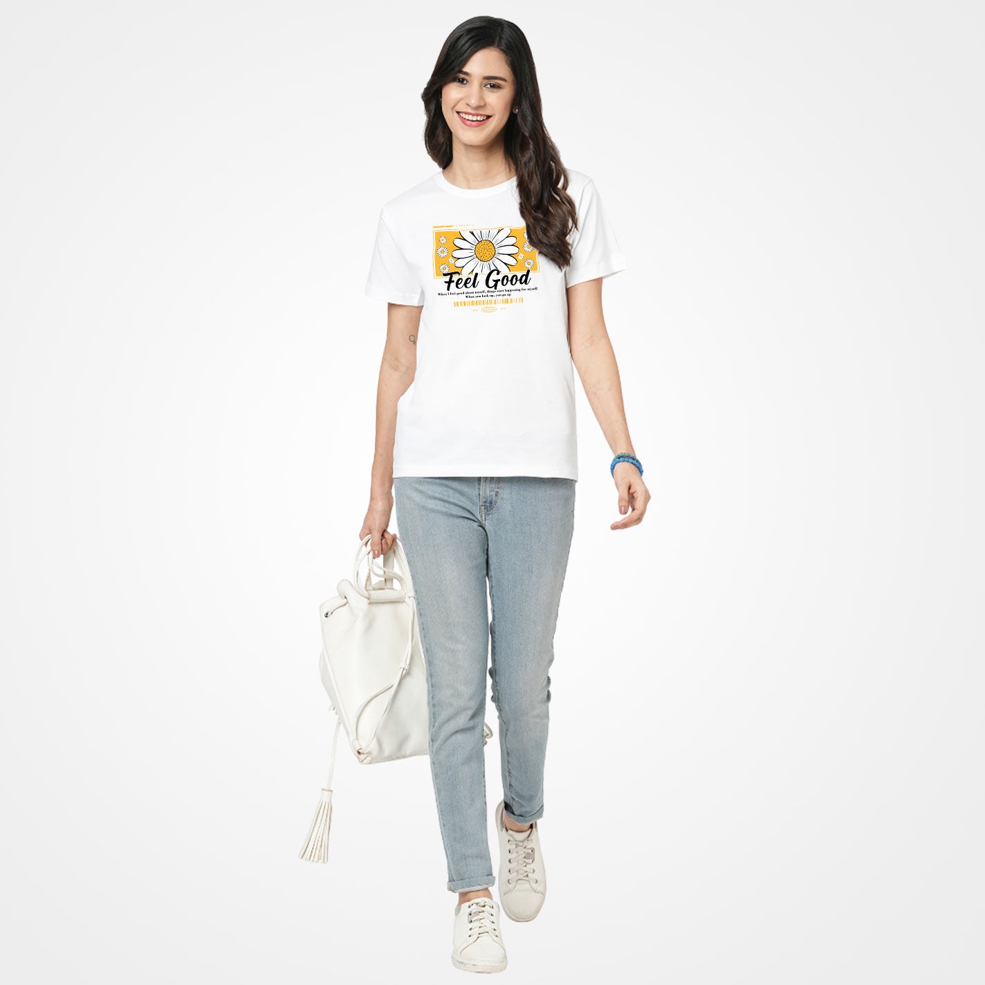 Woman wearing a White t-shirt by WYO with a yellow daisy graphic and 'Feel Good' text on a white background