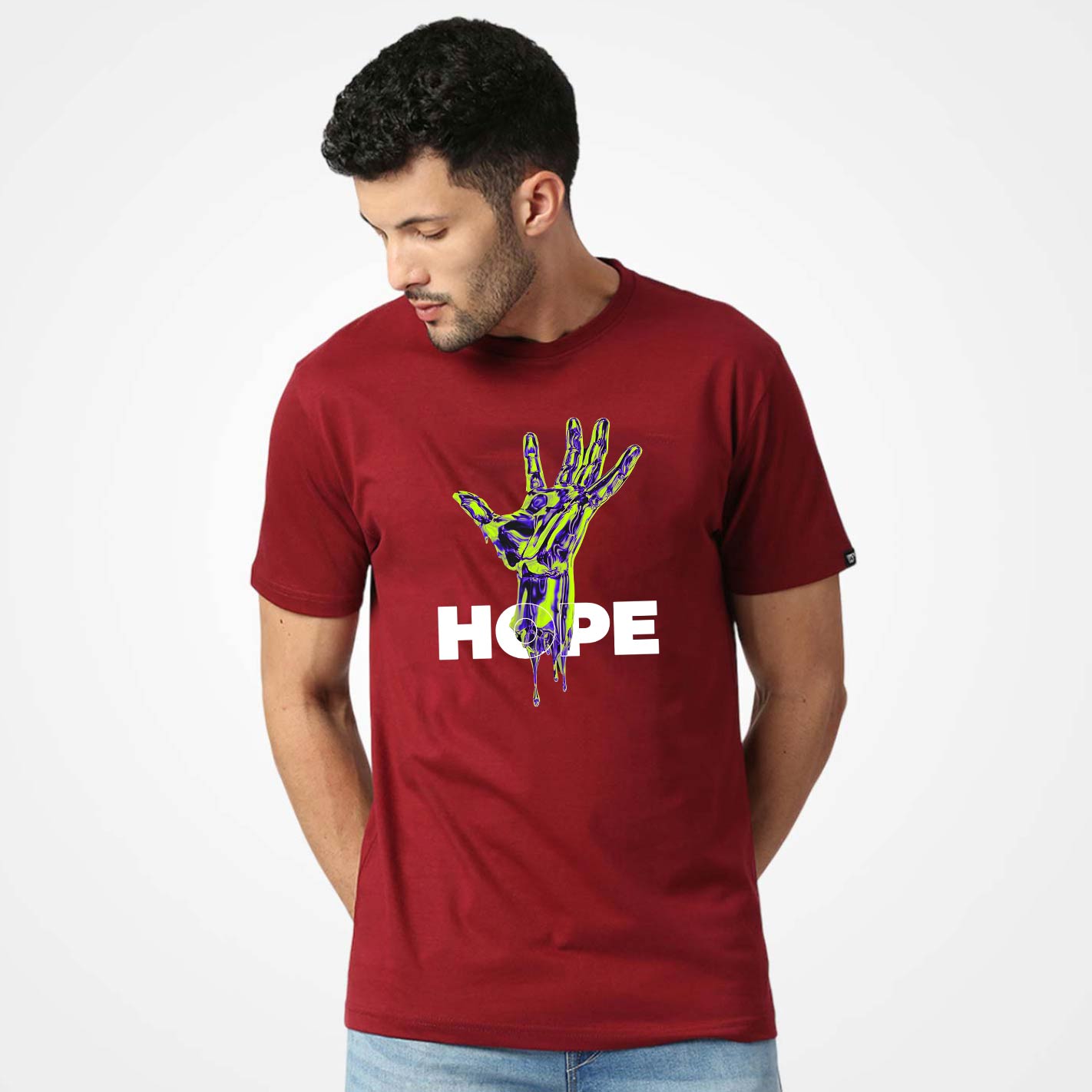Man wearing a WYO maroon t-shirt with a colorful hand design and 'HOPE' text on a white background