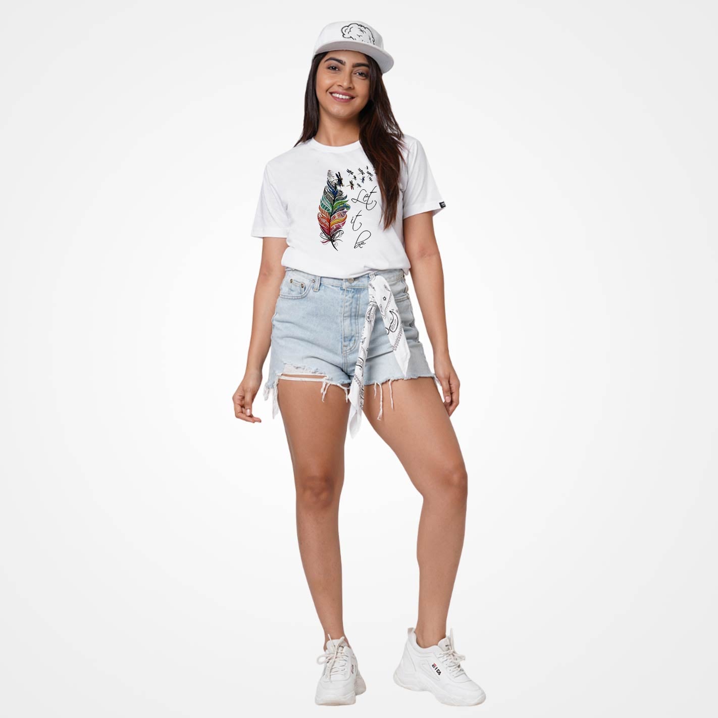 Woman wearing a WYO White t-shirt with colorful feather design and 'Let it be' text on a white background