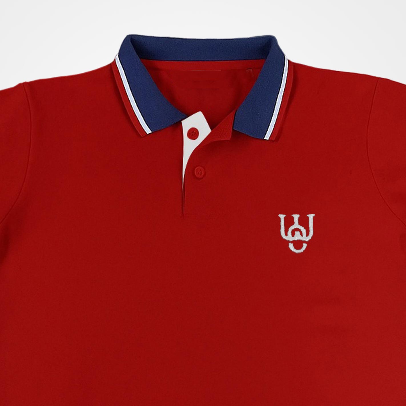 Close view of a WYO Red polo shirt with blue collar and white logo on a white background