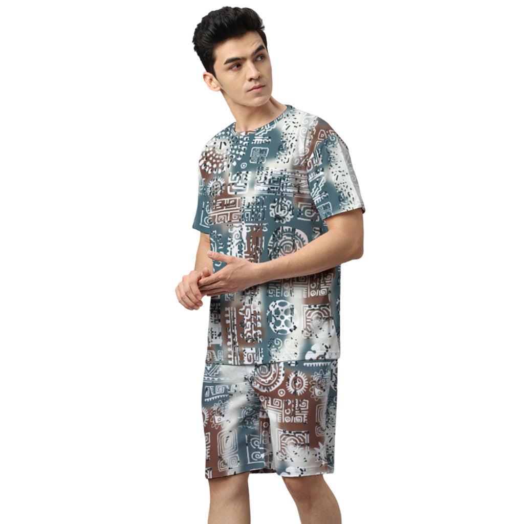 WYO Man wearing a patterned shirt and shorts on a white background