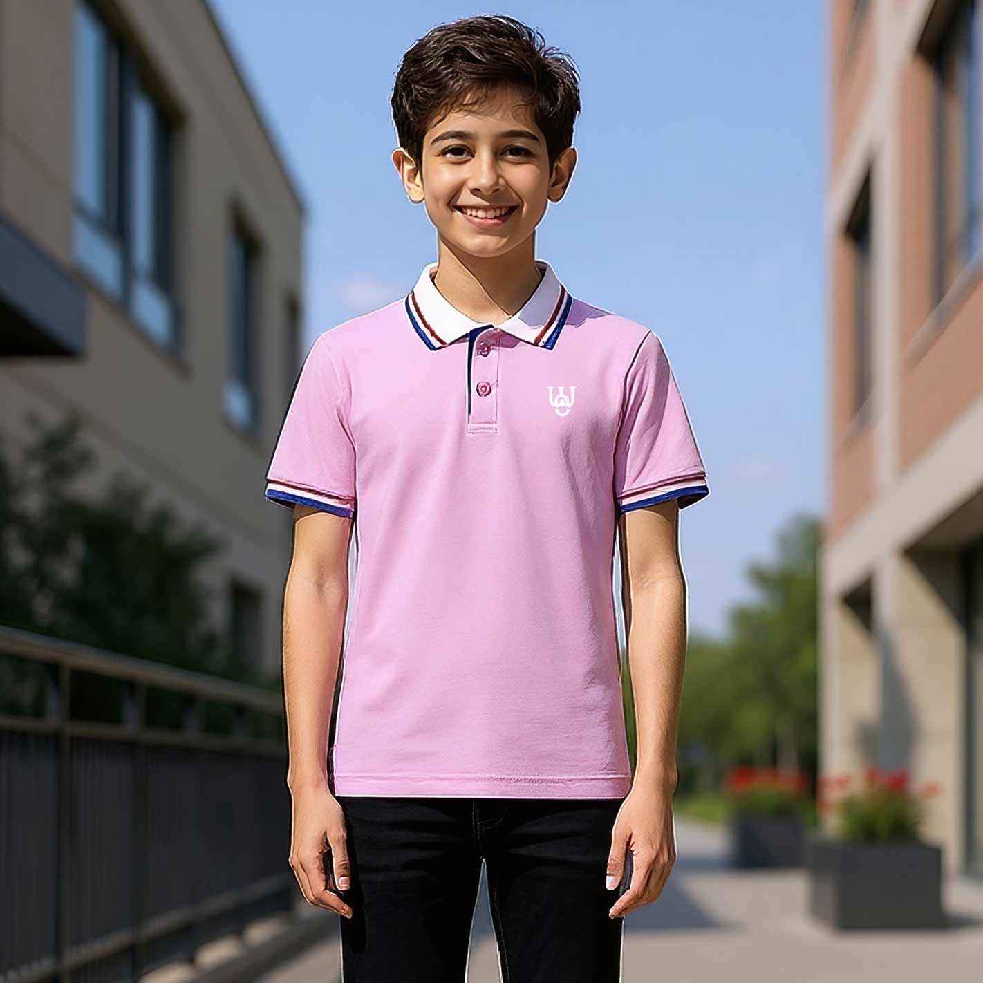 Kid wearing a WYO pink polo shirt with a building and clear sky in the background