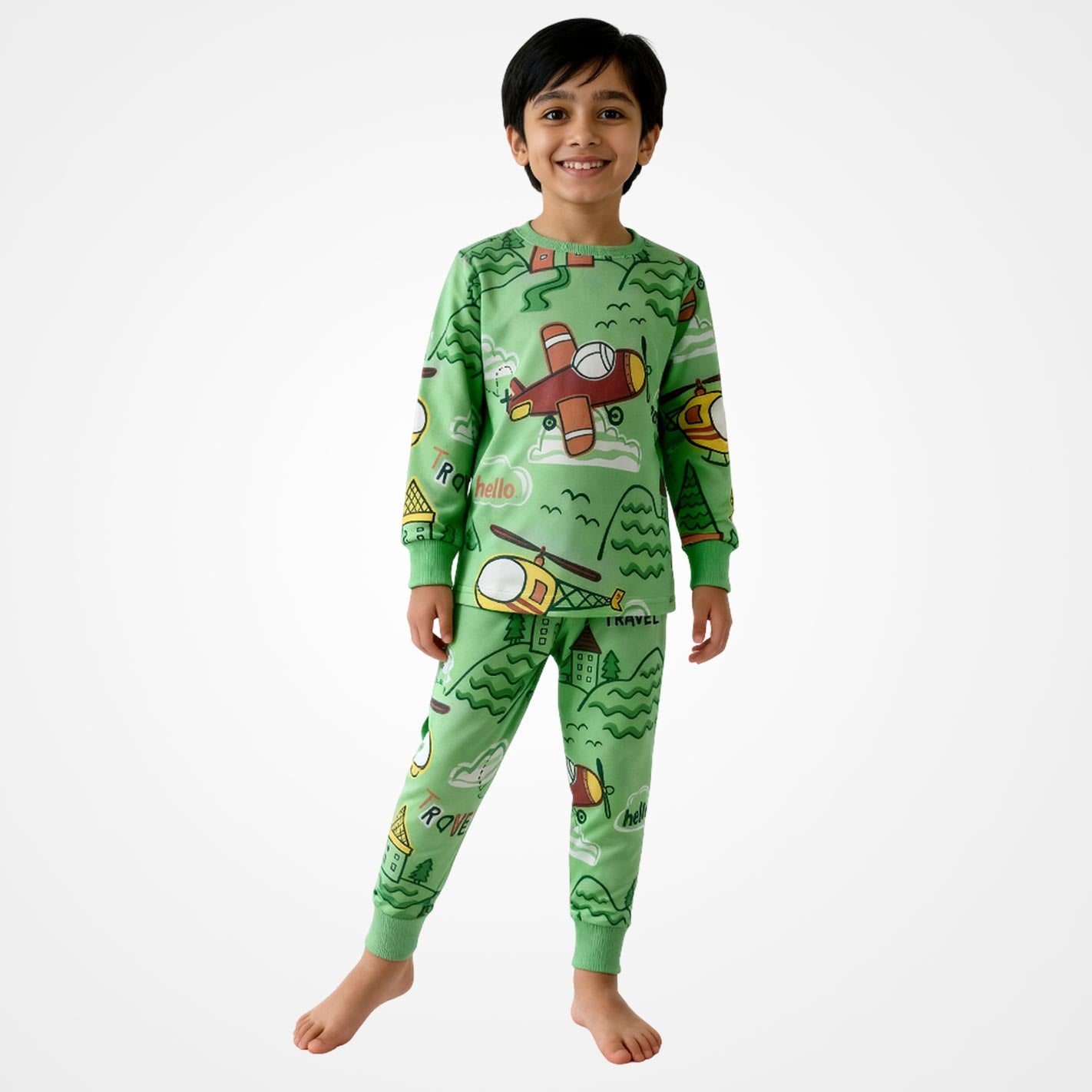 Kid wearing a WYO green pajamas with airplane and car designs on a white background