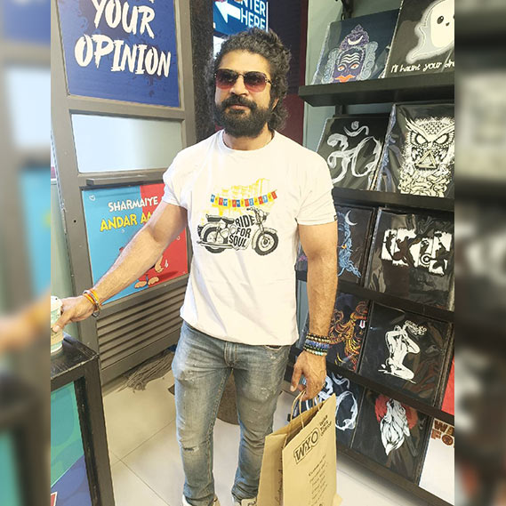 Man in a WYO store with t-shirts on display