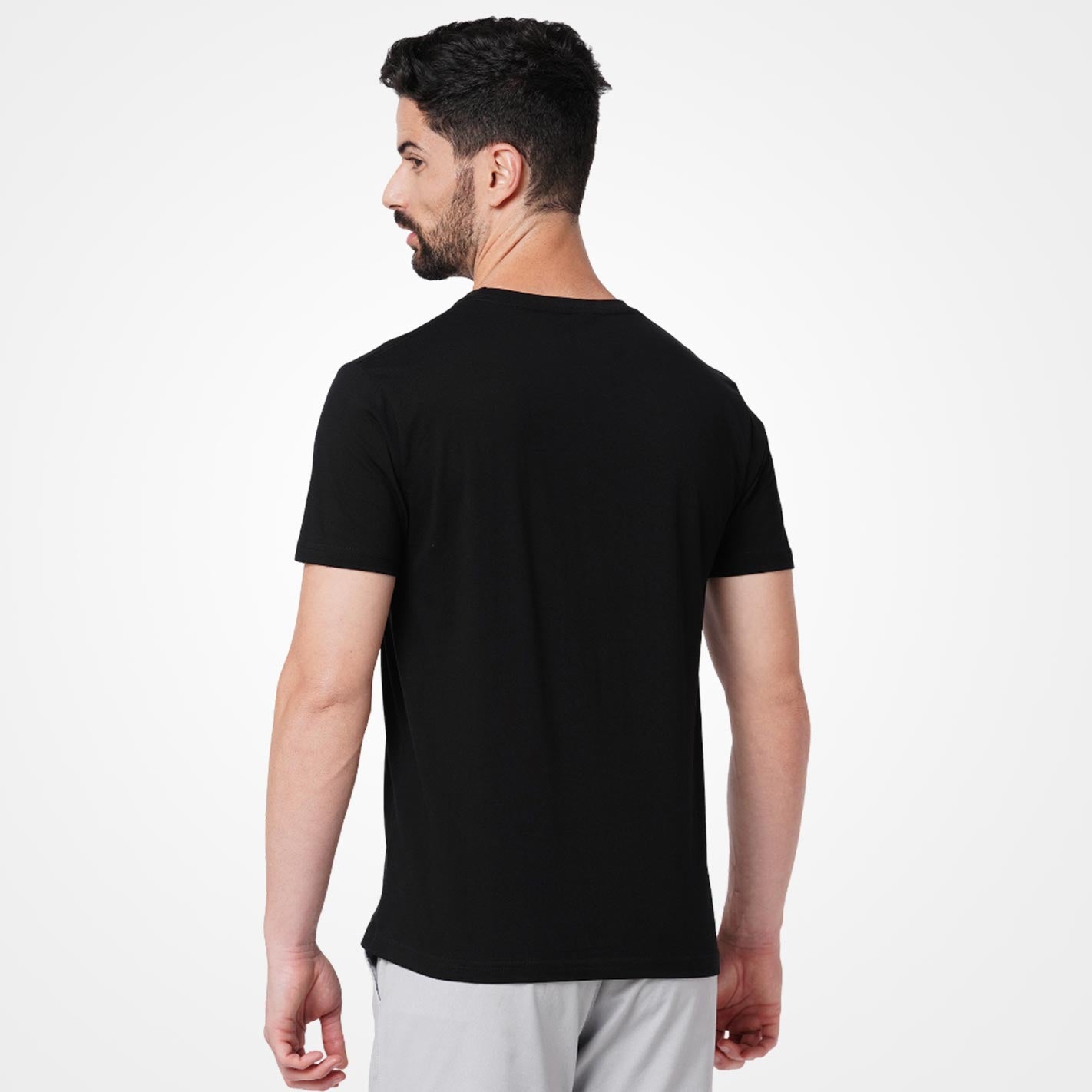 Man wearing a WYO black t-shirt on a white background