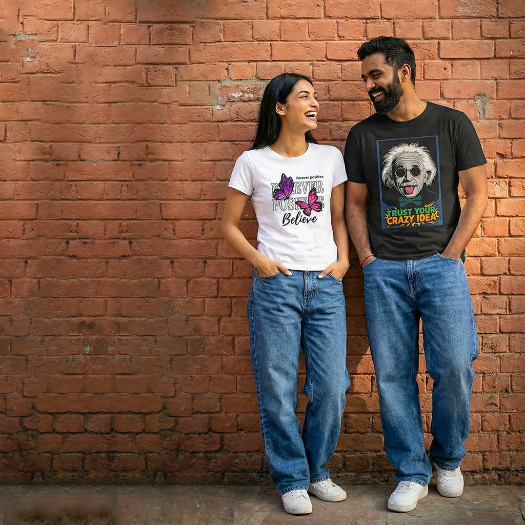 Two people standing against a brick wall, wearing WYO t-shirts with graphic designs.