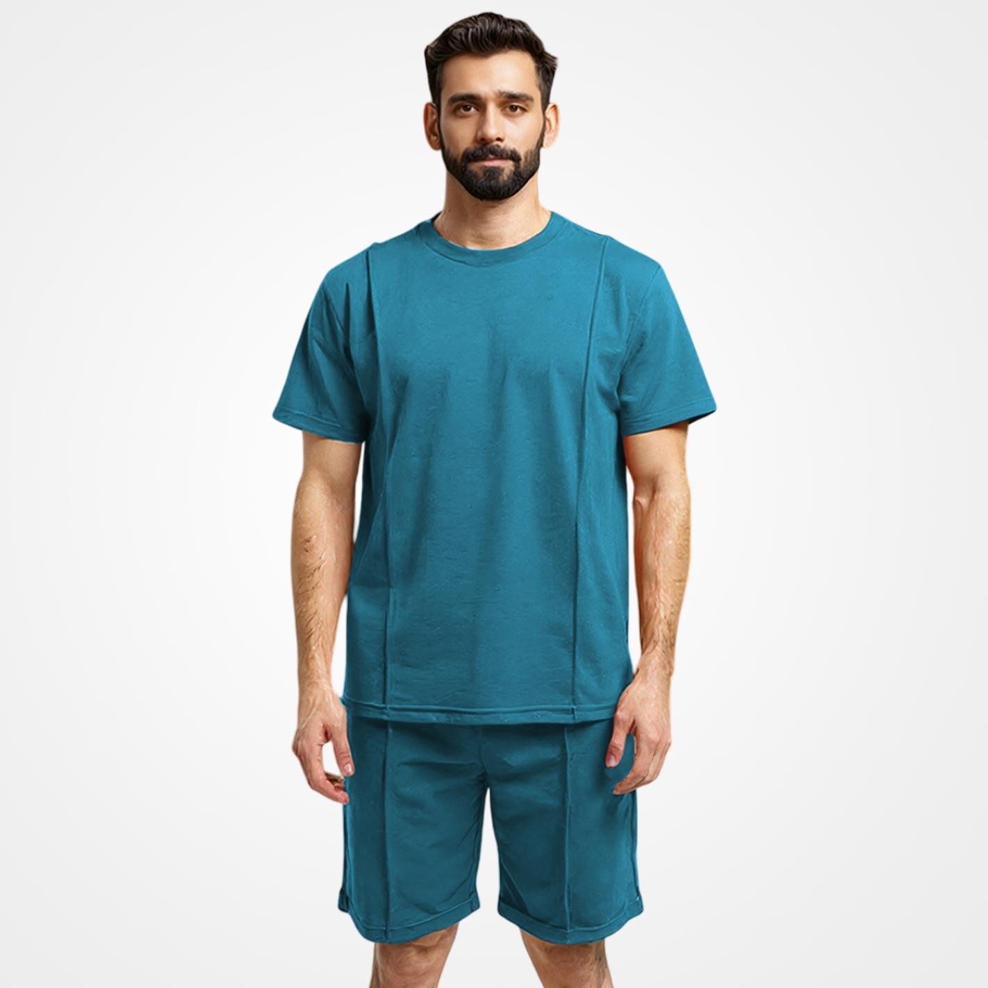 Man wearing a WYO teal t-shirt and shorts set on a white background