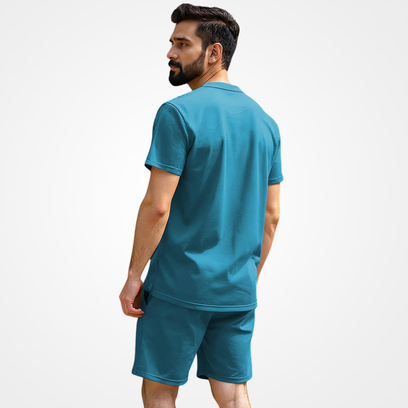 Back View Of a Man wearing a WYO teal t-shirt and shorts set on a white background