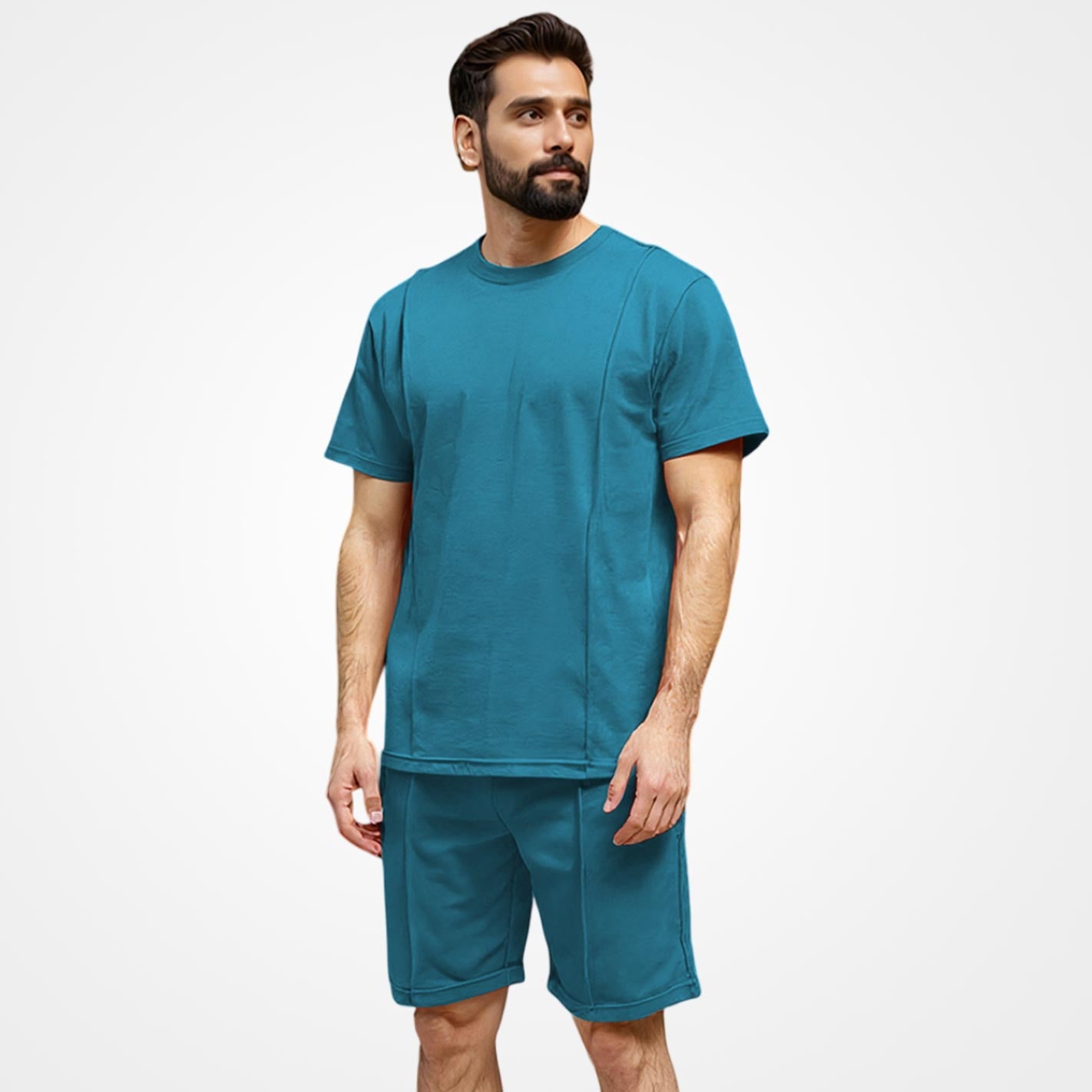 Man wearing a WYO teal t-shirt and shorts set on a white background