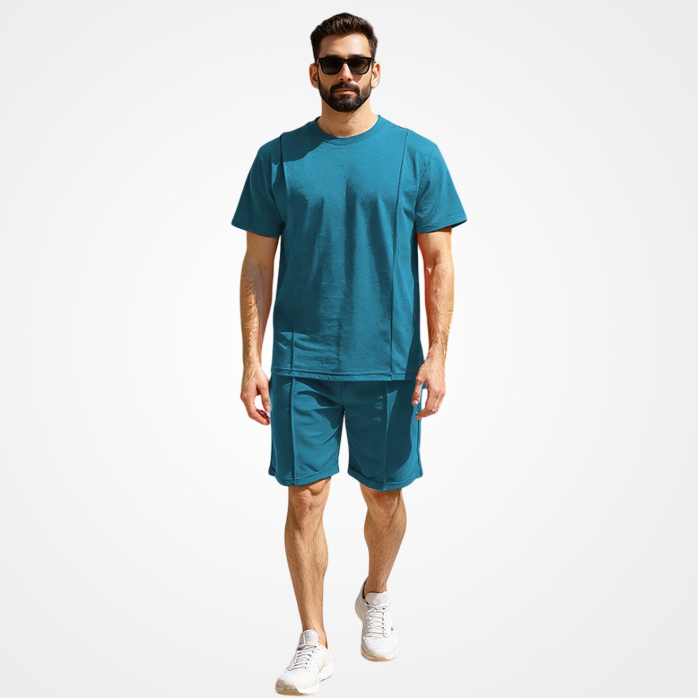 Man wearing a WYO teal t-shirt and shorts set on a white background
