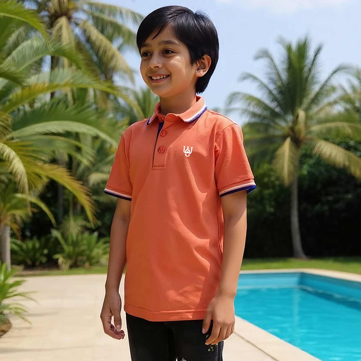 Kid wearing an WYO Carrot  polo shirt with a logo by a poolside with palm trees in the background