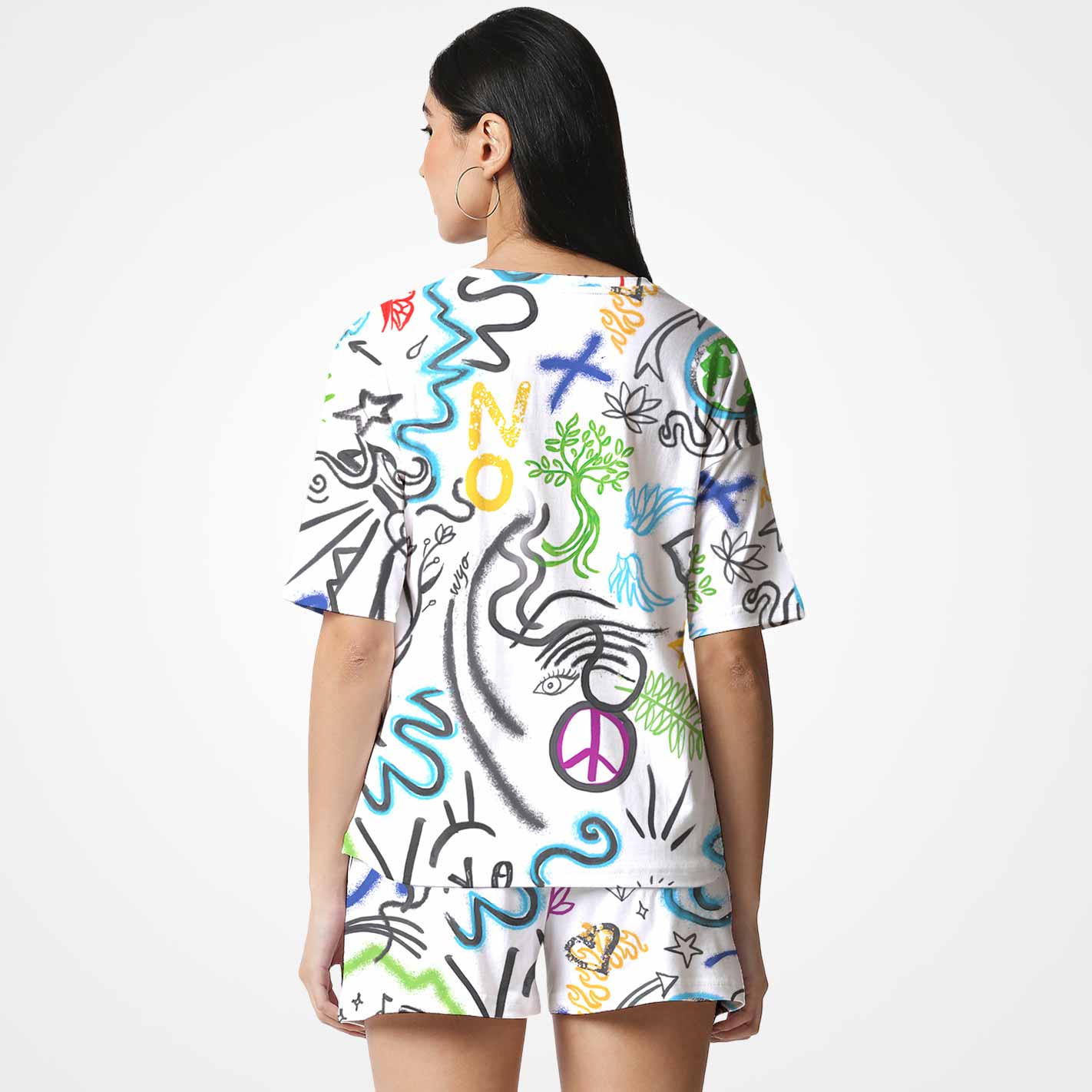 Back view of a woman wearing a WYO colorful graphic t-shirt with abstract designs on a white background