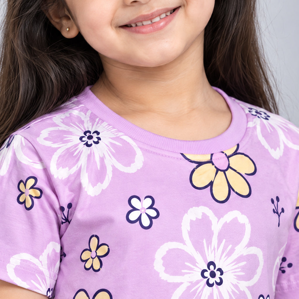 Close-up of a lilac girls’ WYO Flower Power co-ord set, showing its crew-neck top and white, yellow, and navy floral print.