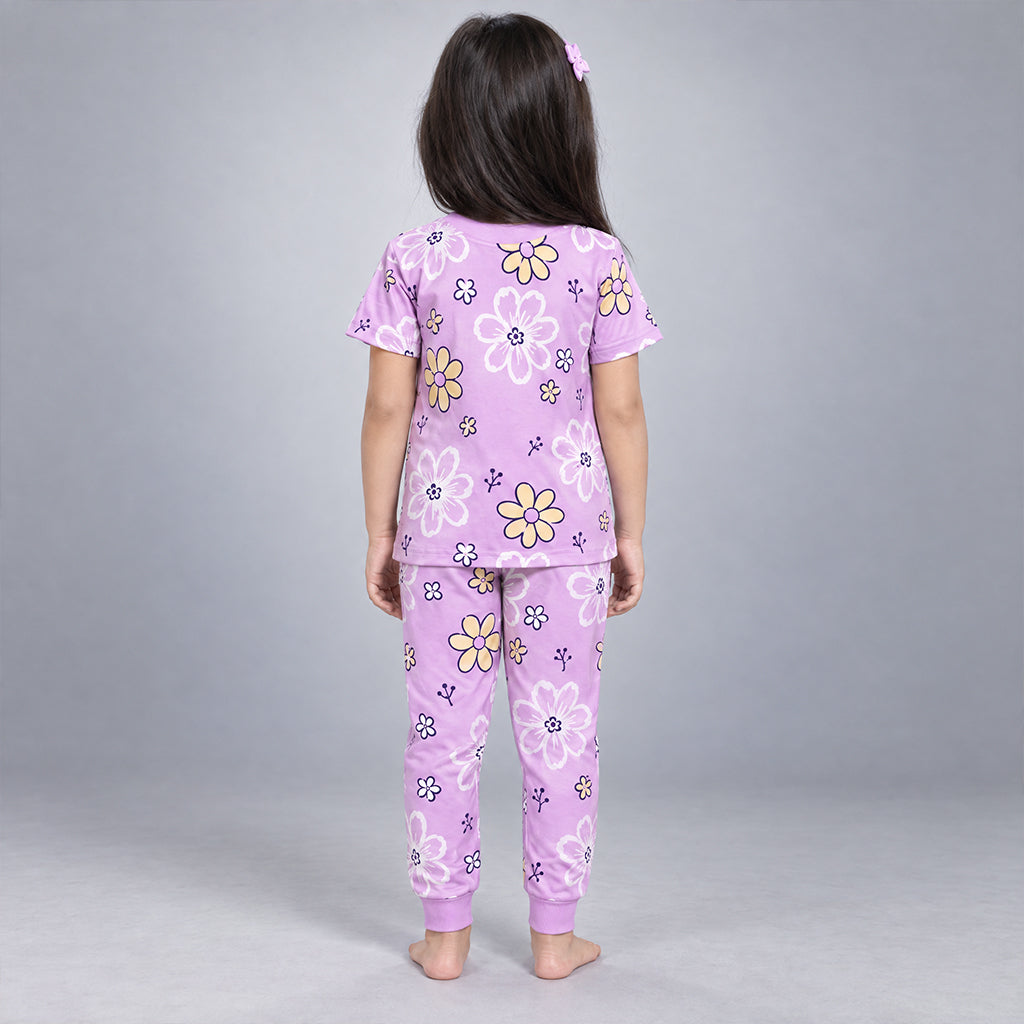 Back view of a girl wearing the lilac WYO Flower Power floral co-ord set with matching top and jogger pants.
