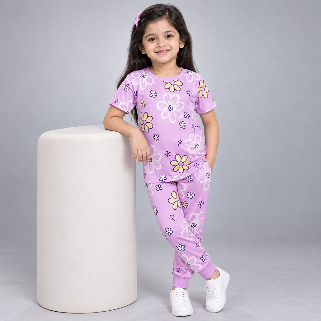 Girl modeling a lilac WYO Flower Power co-ord set with a floral-print T-shirt and matching jogger pants.