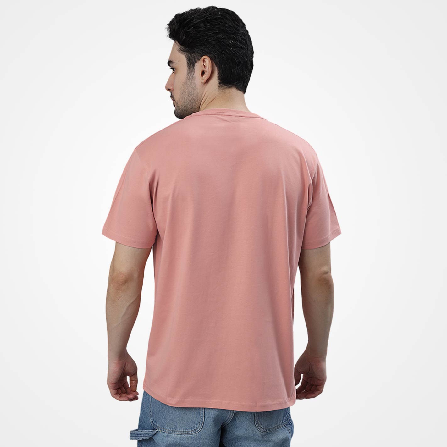 Man wearing a WYO peach t-shirt on a white background