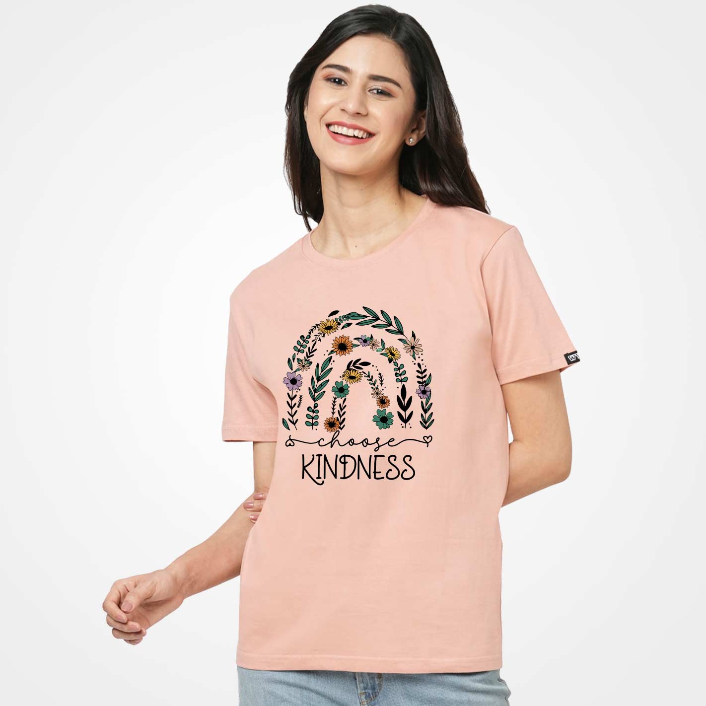 Woman wearing a Peach t-shirt by WYO with floral design and 'Choose Kindness' text on a white background