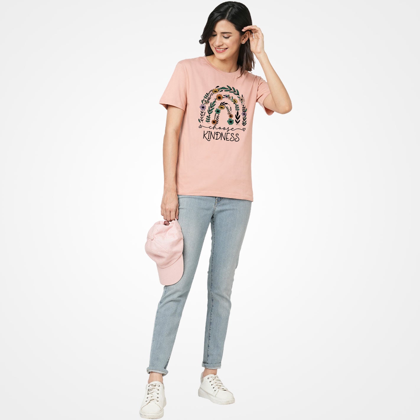 Woman wearing a Peach t-shirt by WYO with floral design and 'Choose Kindness' text on a white background