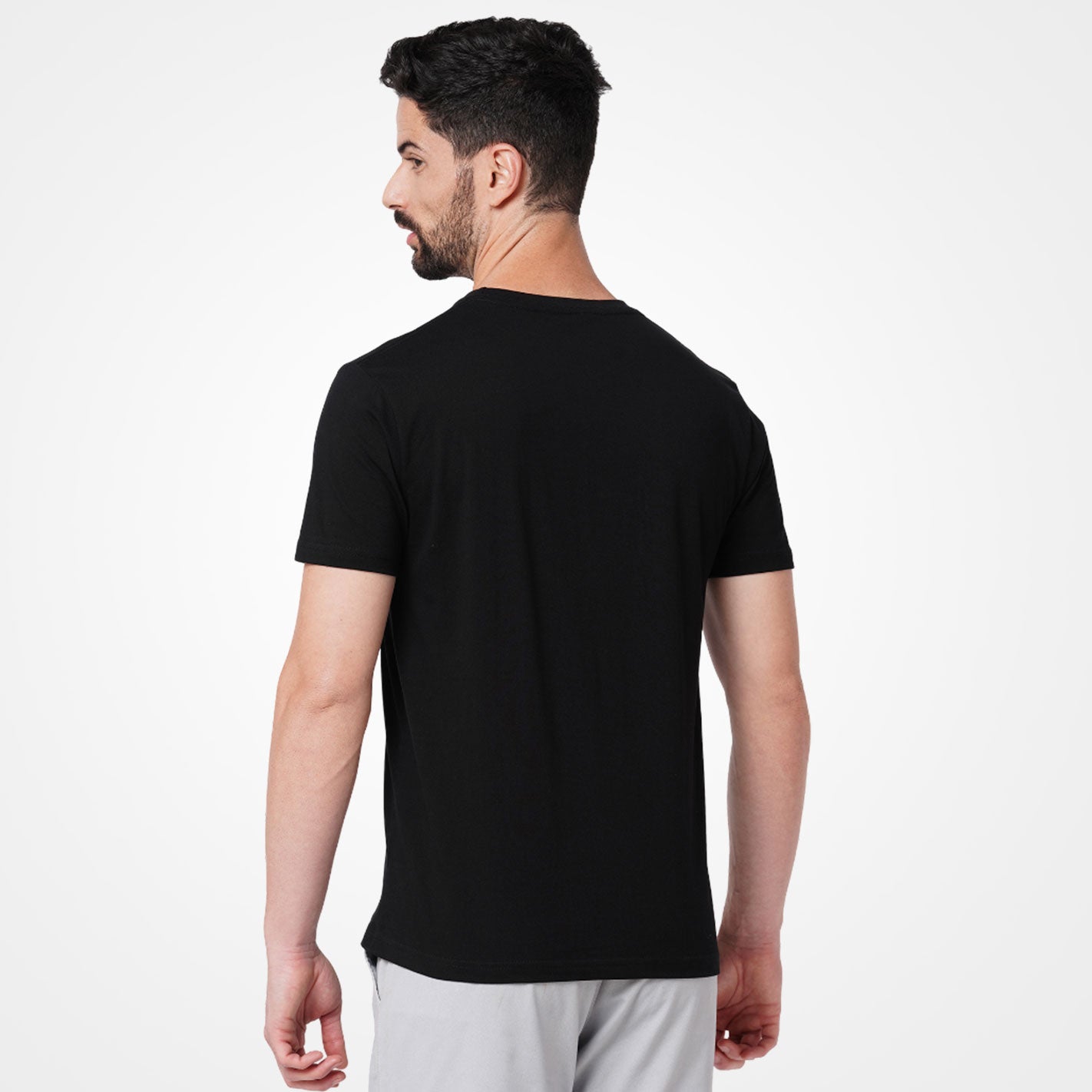 Man wearing a WYO black t-shirt on a white background