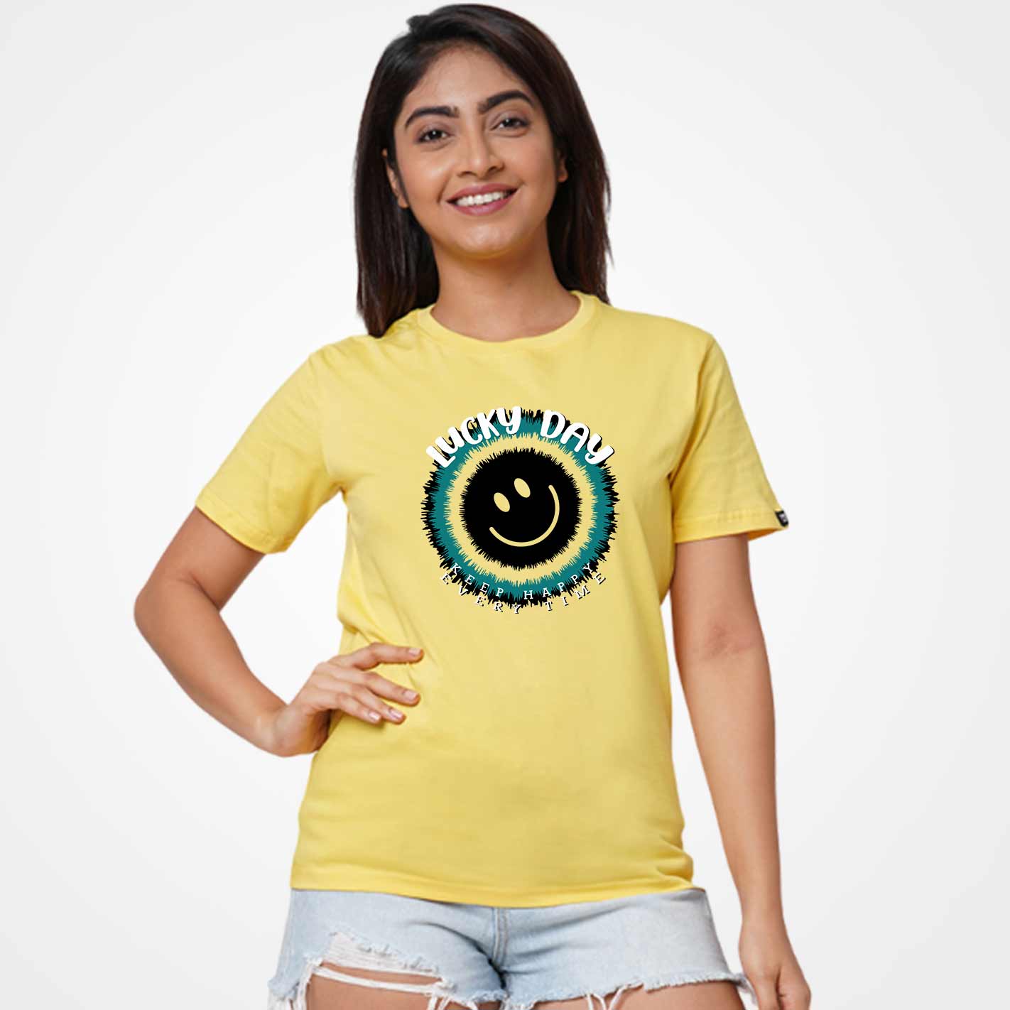 Woman wearing a WYO yellow t-shirt with a smiley face design on a plain background