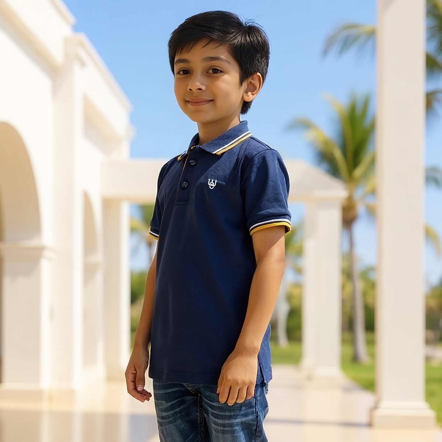 Kid wearing a WYO navy blue polo shirt with a logo, standing in front of palm trees.