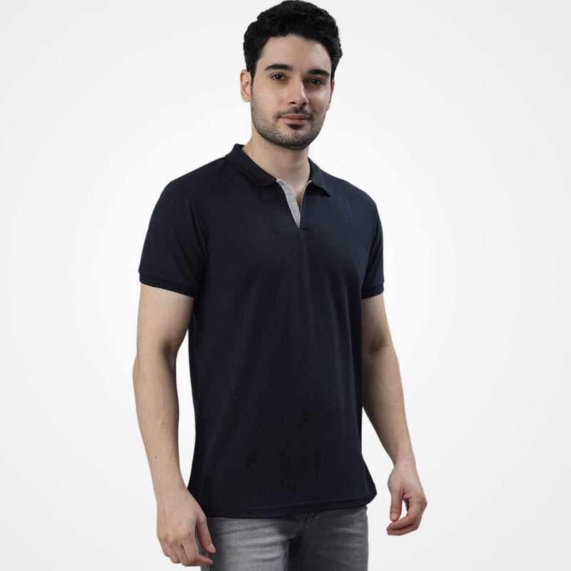 Man wearing a WYO black polo shirt on a white background