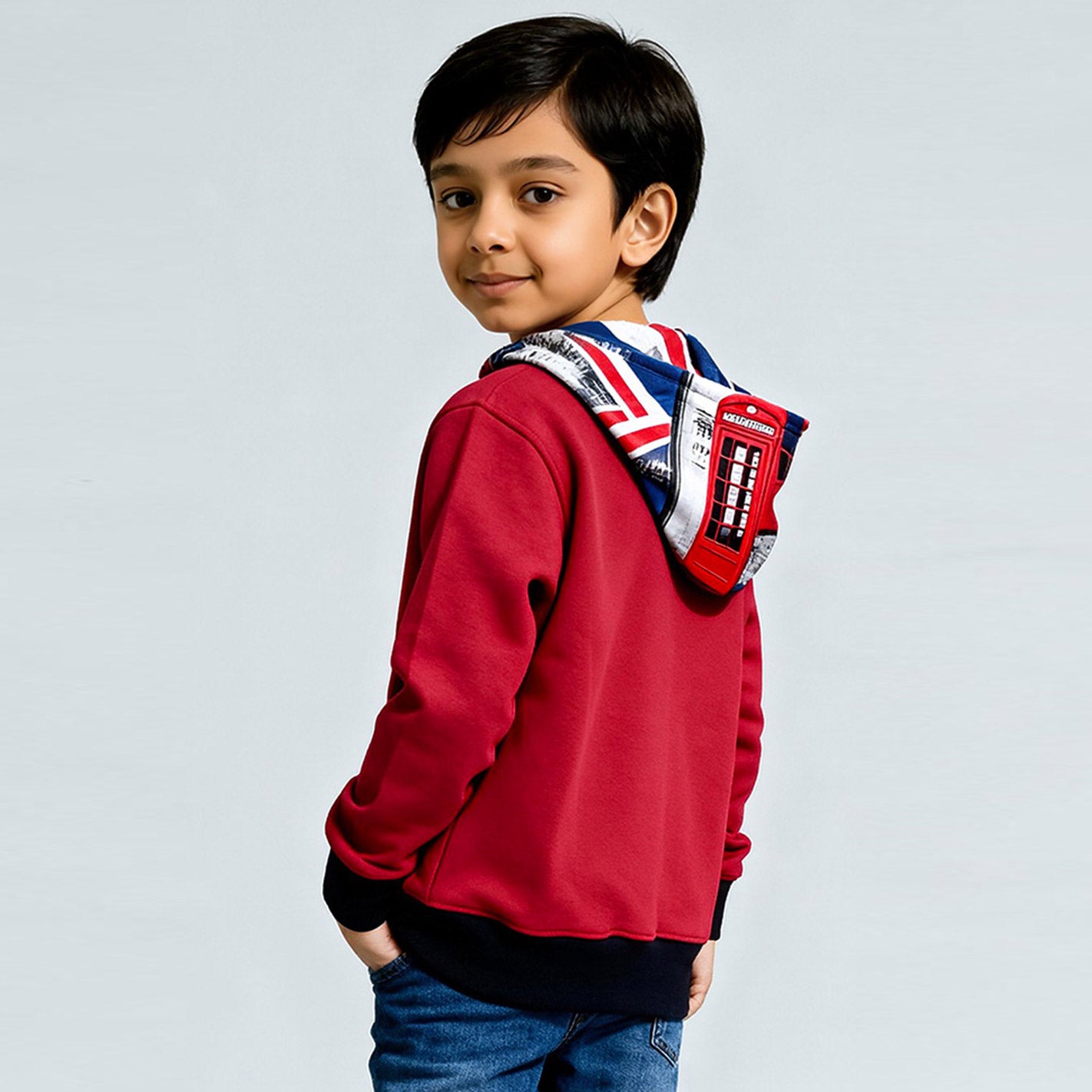 Child wearing a WYO red hoodie with a Union Jack design on a light gray background