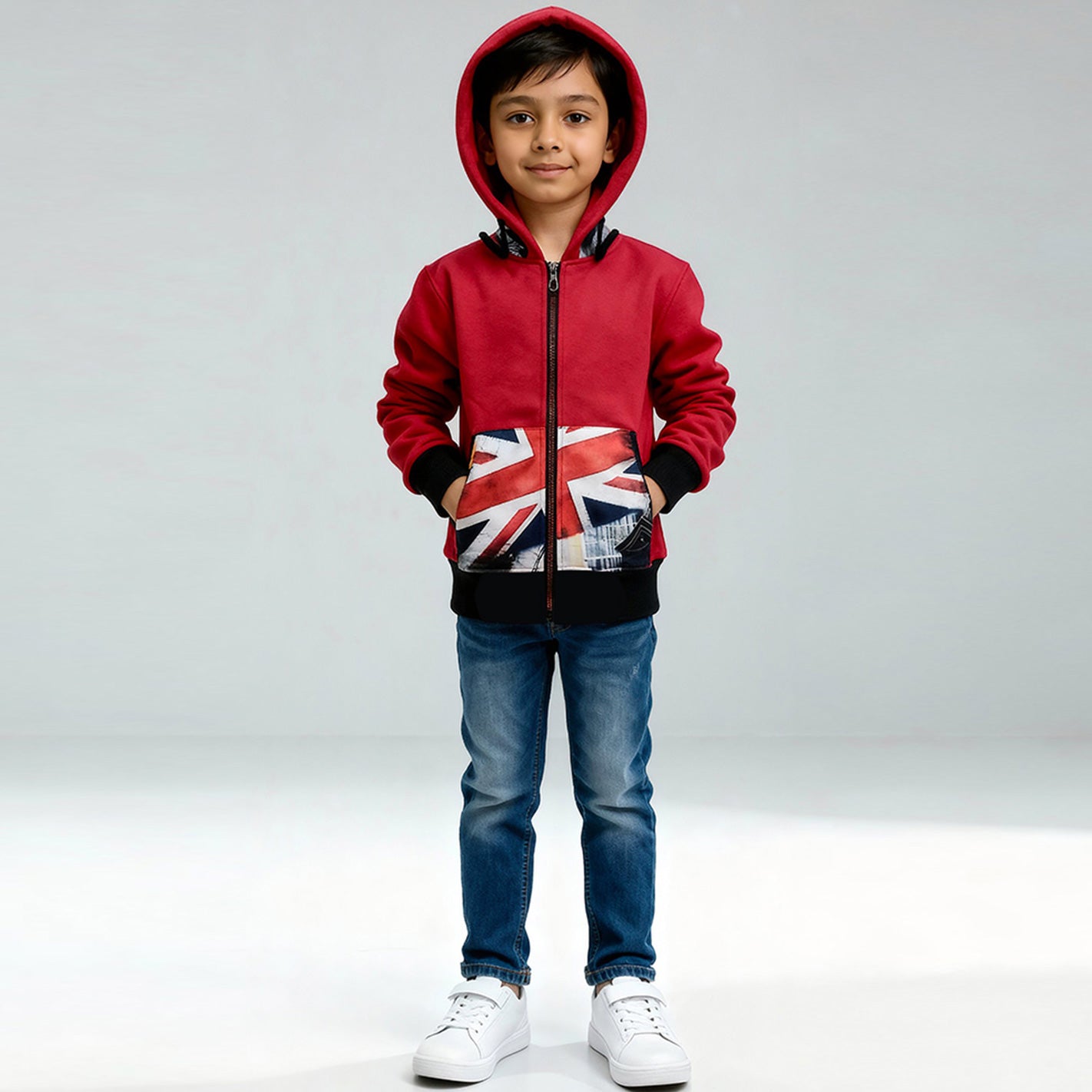 Child wearing a WYO red hoodie with a Union Jack design on a gray background
