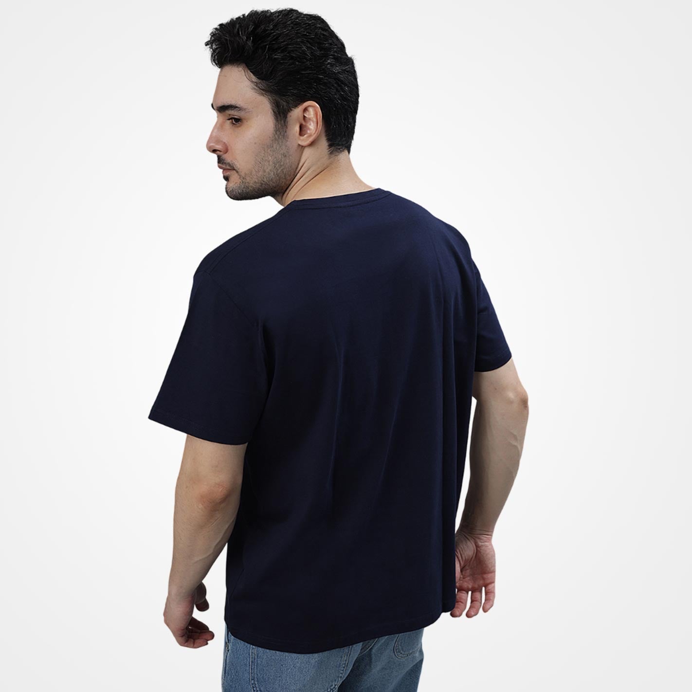 Man wearing a WYO navy blue t-shirt on a white background