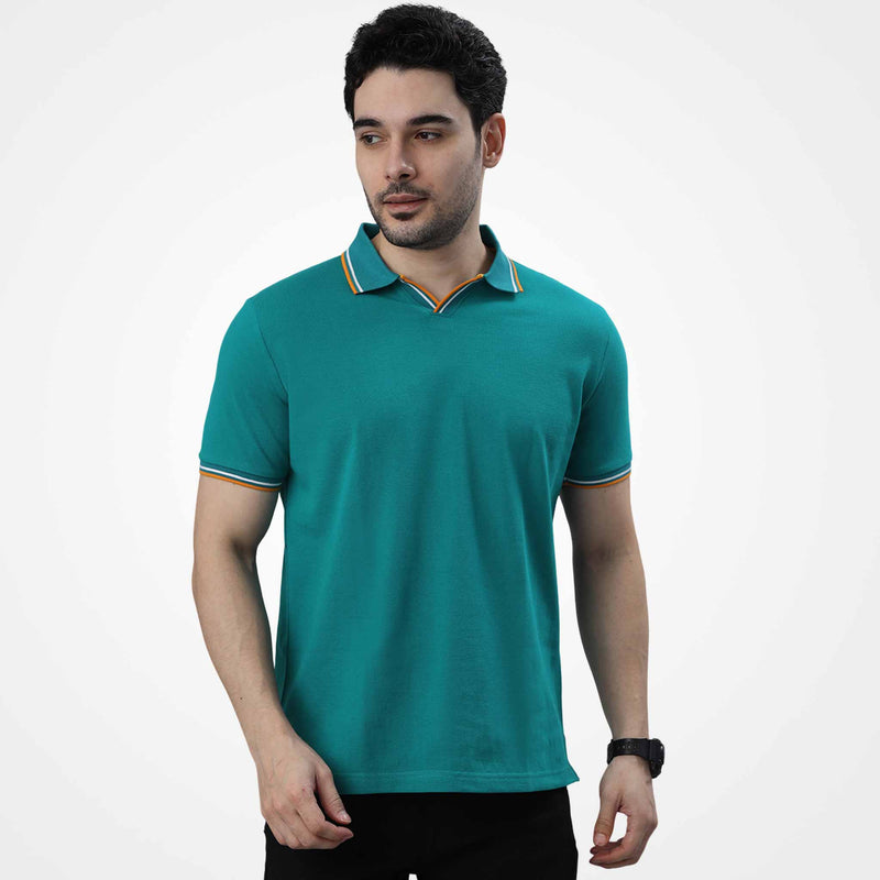 Man wearing a WYO teal polo shirt on a white background