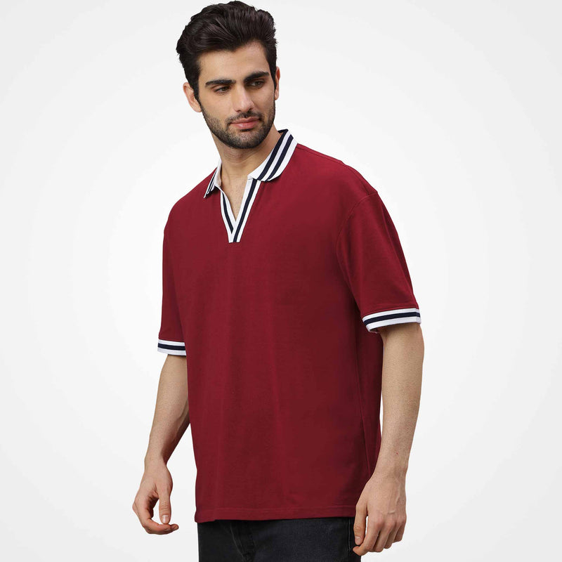 Man wearing a WYO Maroon polo shirt with white and navy accents on a white background