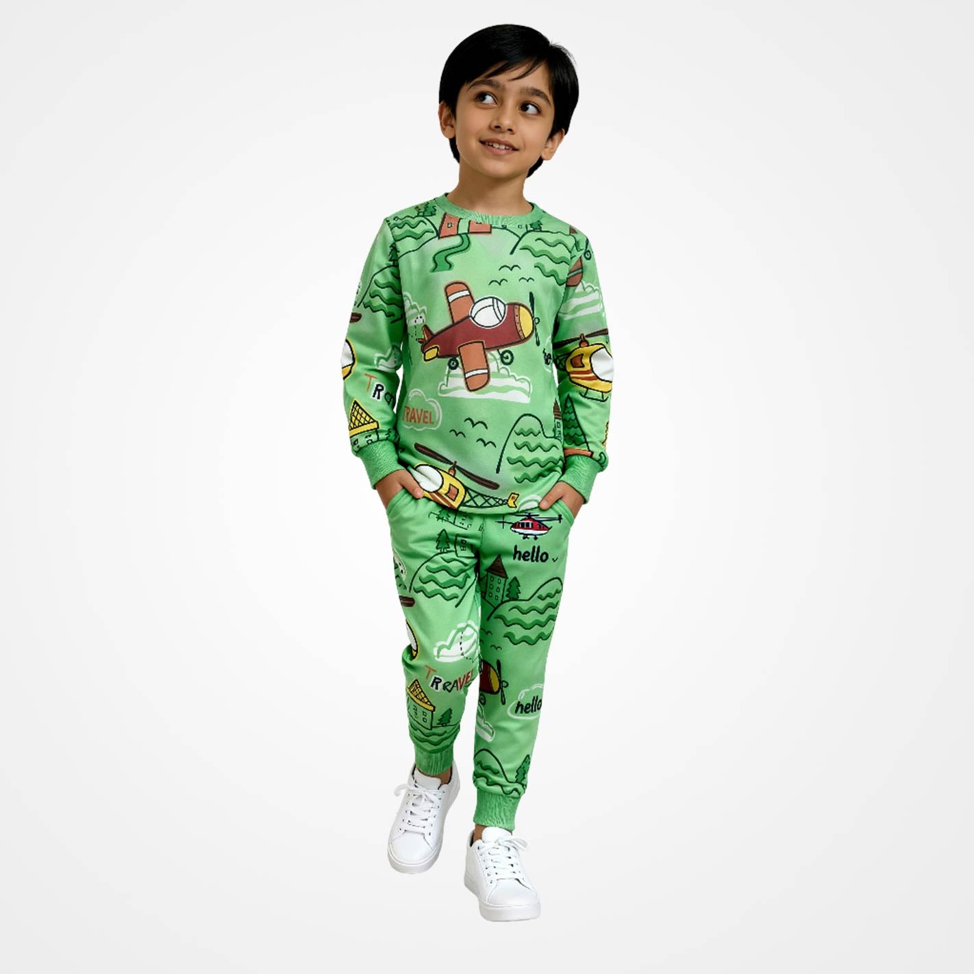Kid wearing a WYO green pajama set with airplane design on a white background