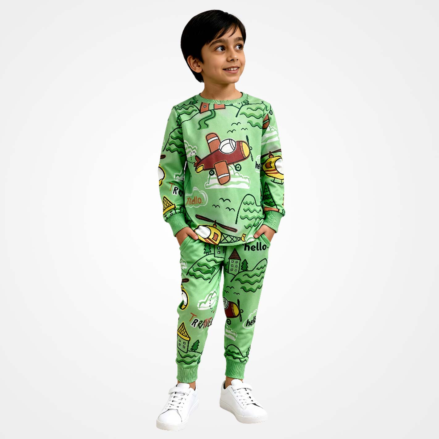 Kid wearing a WYO green pajama set with airplane design on a white background