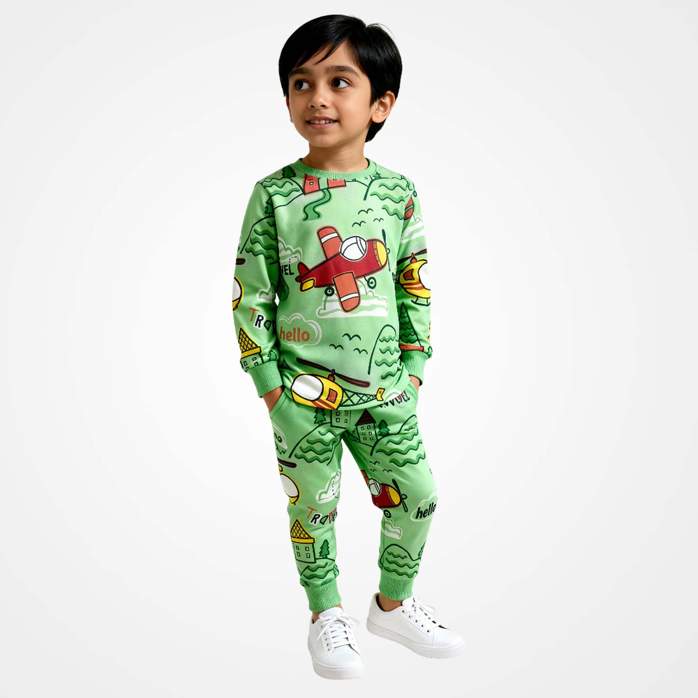 Kid wearing a WYO green pajama set with airplane design on a white background