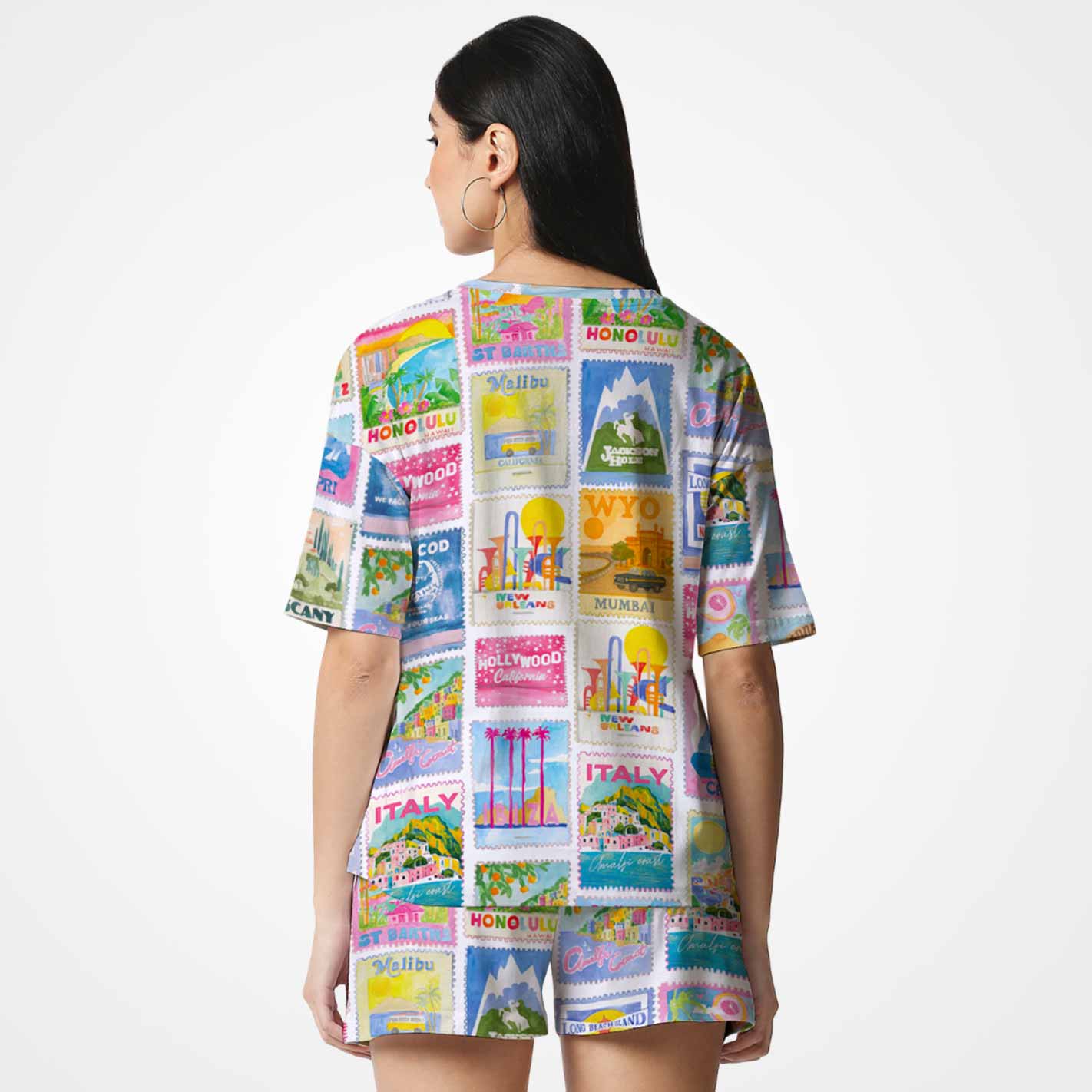 Back view of a Woman wearing a WYO colorful shirt with travel-themed designs on a white background