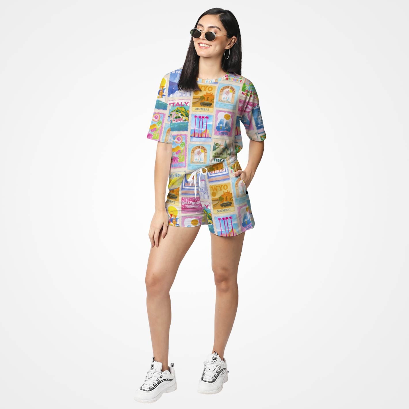 Woman wearing a WYO colorful outfit with a patterned shirt and shorts on a white background